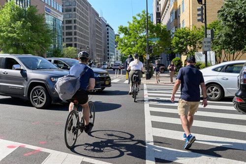 A group of people riding bicycles on a street

AI-generated content may be incorrect.